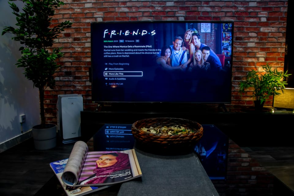 TV screen showing Netflix interface with Friends TV show ready to play